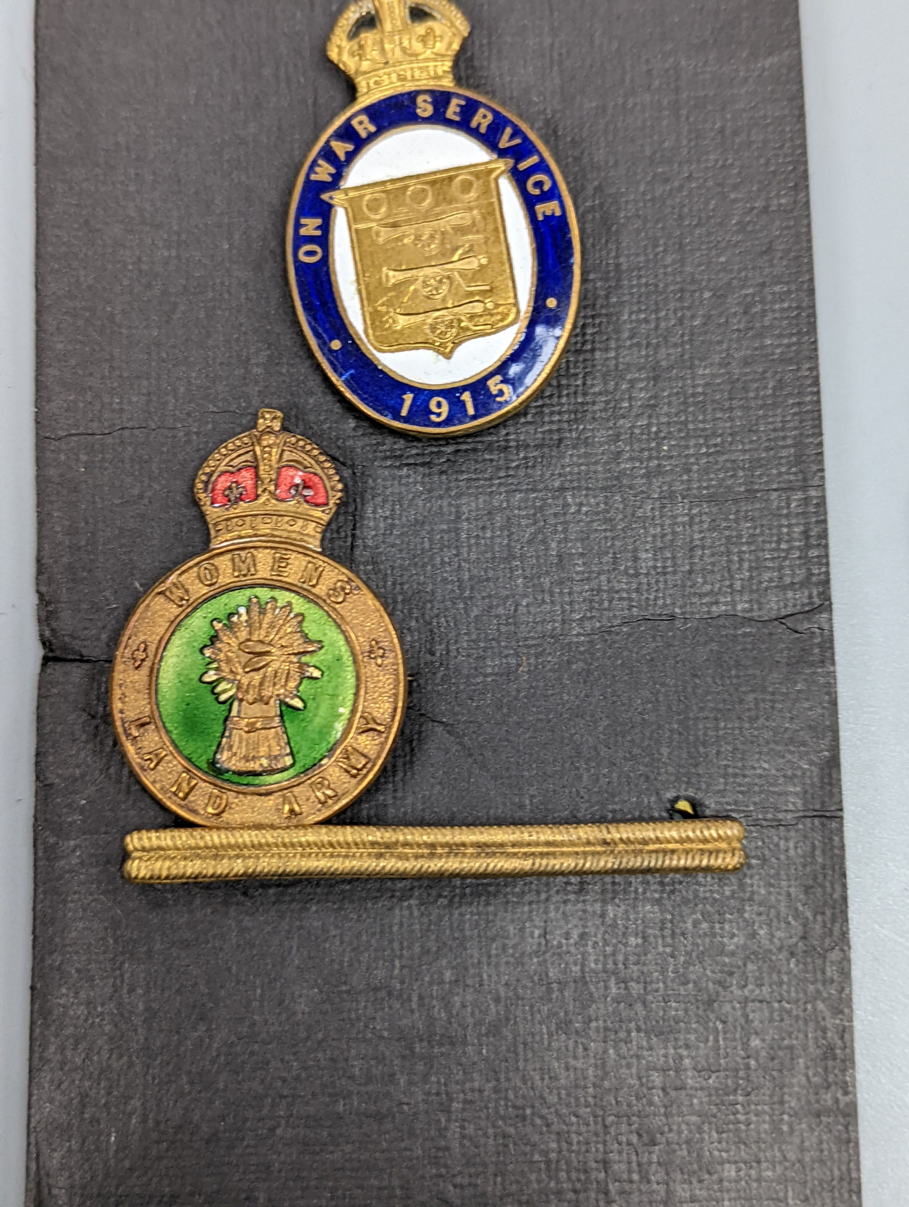 A George VI Territorial For Efficient Service medal, ARP, On War Service, Women’s Land Army badges, UN medal and other badges and medals and a quantity of reference books